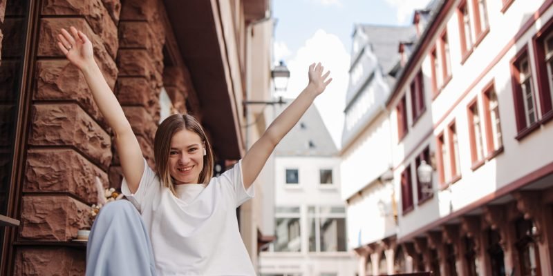 view-pretty-cute-woman-smiling-camera-with-hands-up